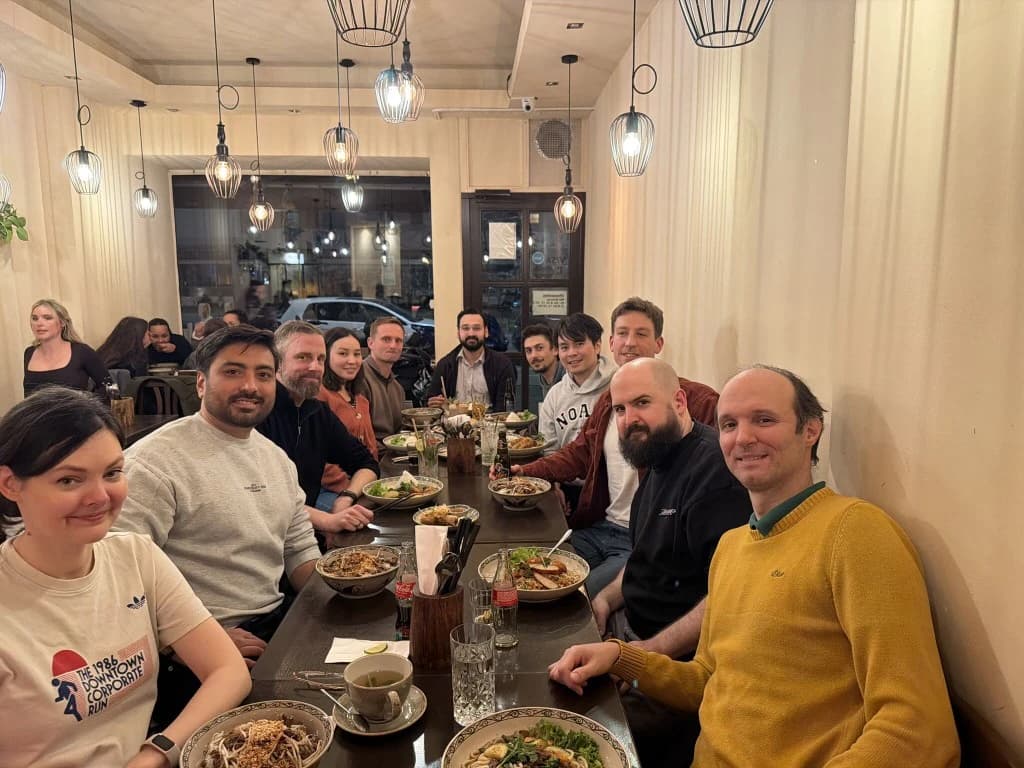 DATANOMIQ team sharing a meal together at a restaurant.